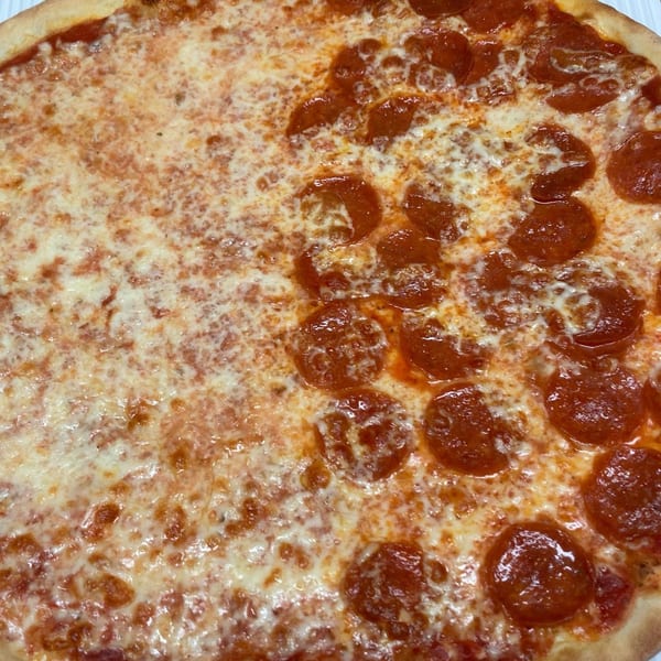 Half cheese and half pepperoni pizza with a golden crust, close-up.